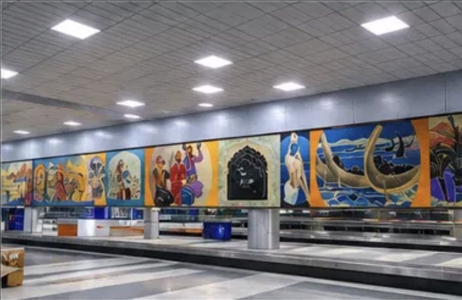 Long painted mural above the baggage carousels