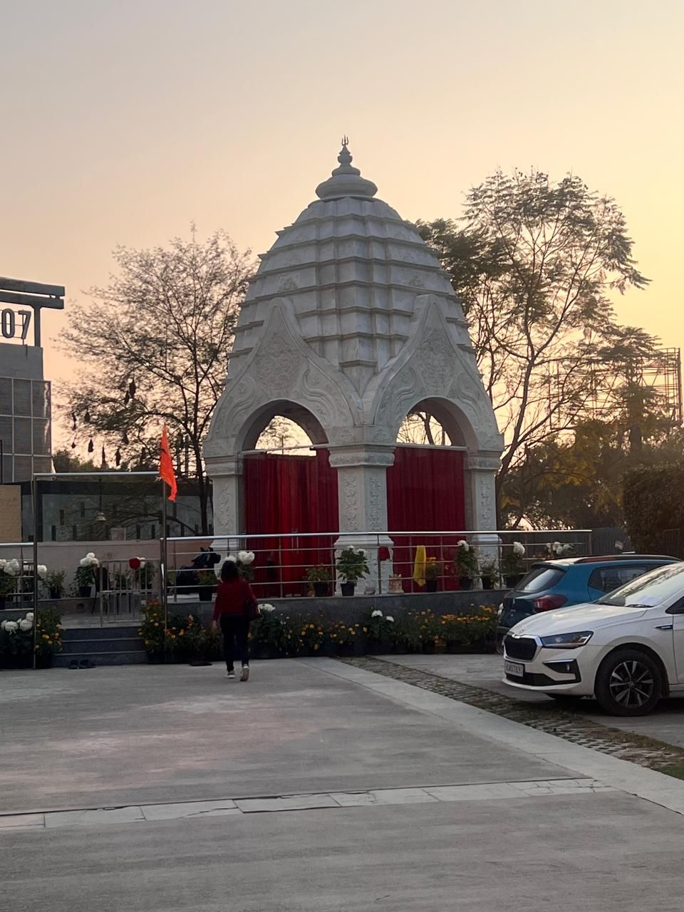 The marble temple with its twin arches and tiered spire against an evening sky