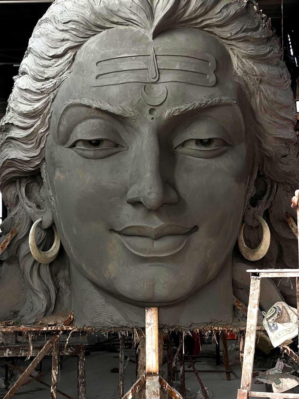 Large sculpted Shiva head on steel staging in the workshop