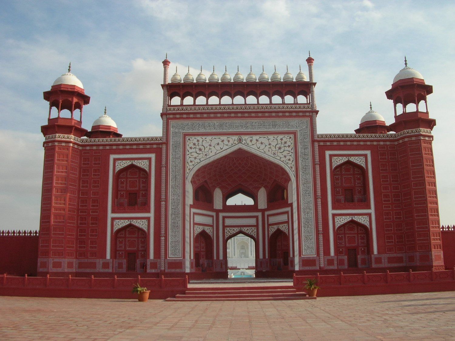 Red sandstone-style gateway with white inlay