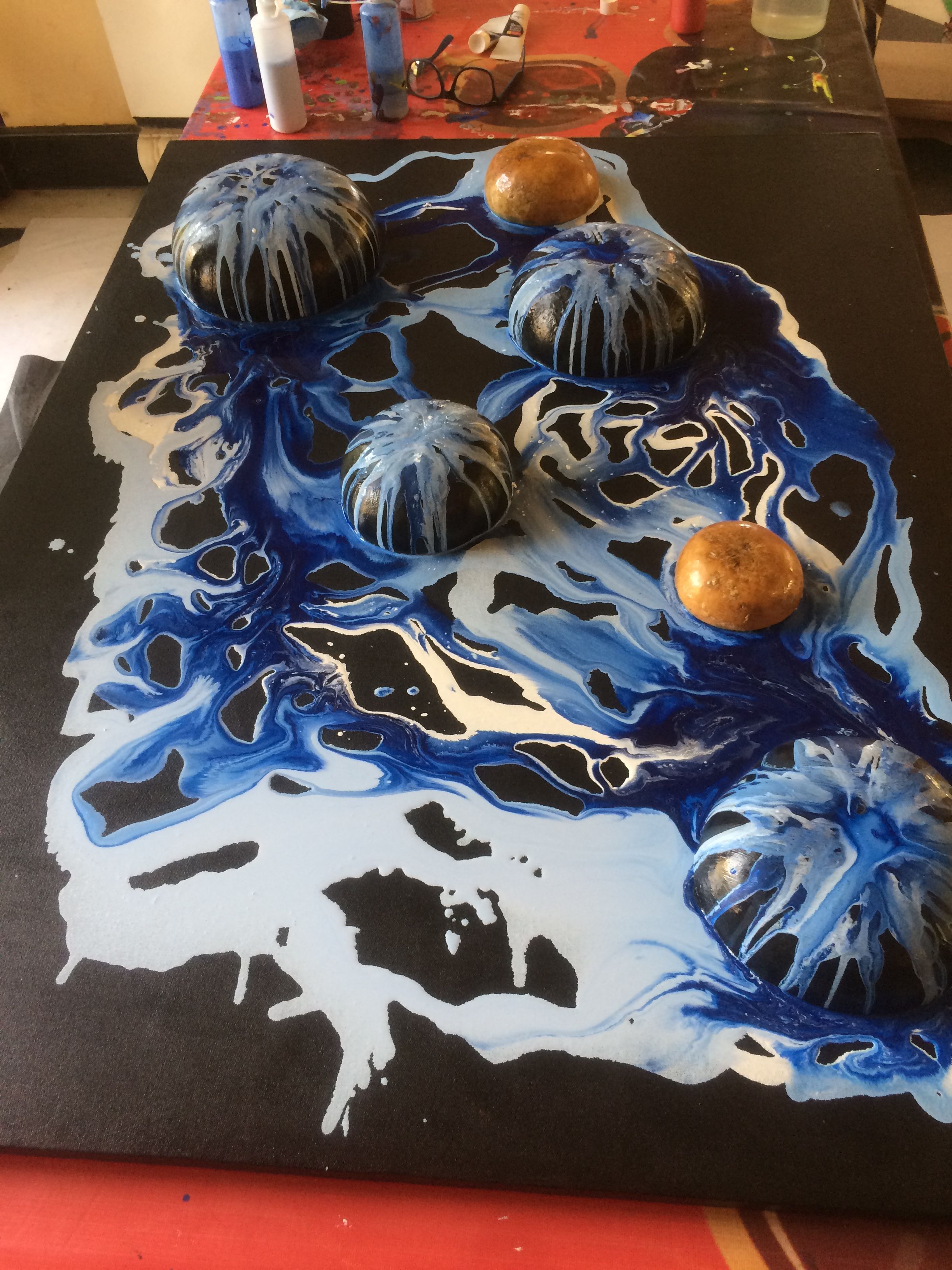 Blue poured artwork with resin domes, close up