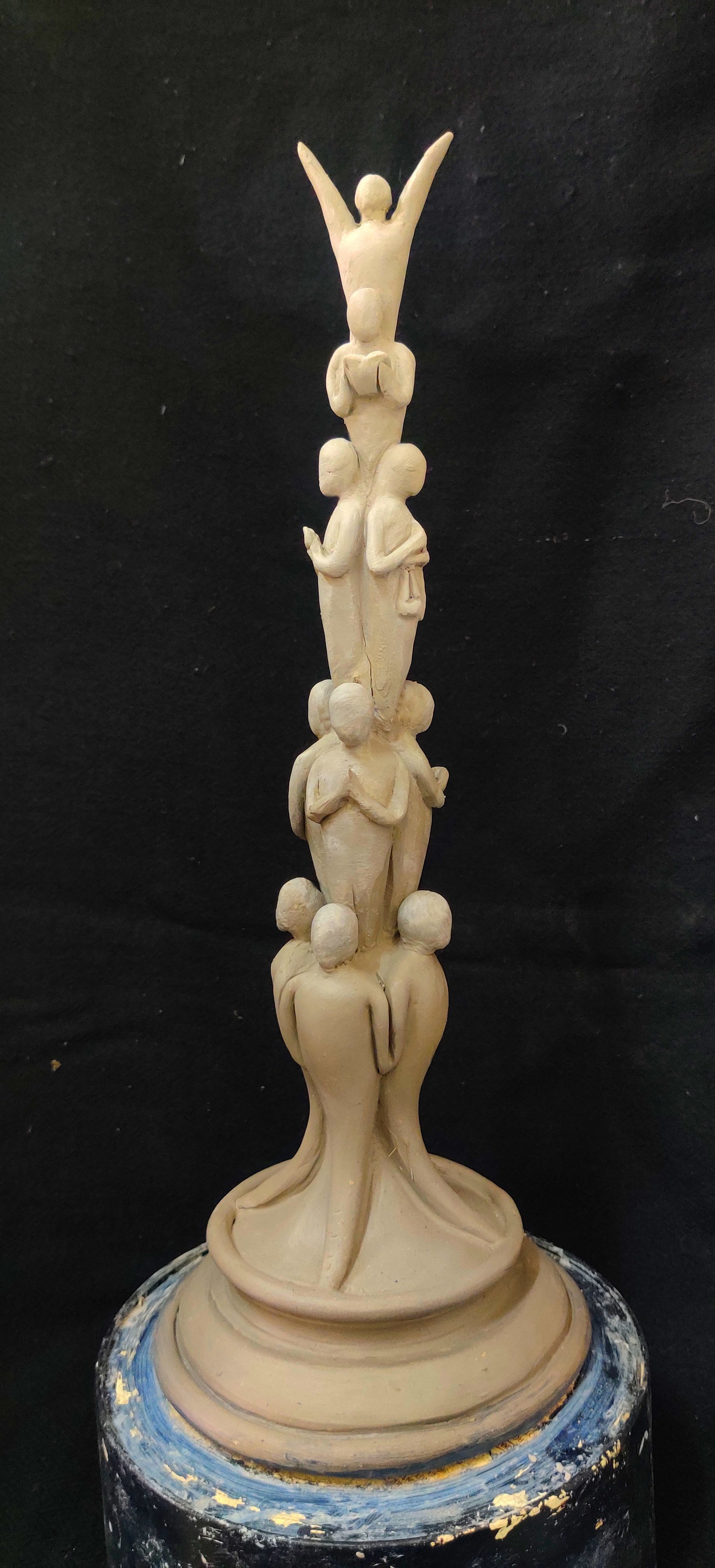 Photograph of a tall maquette of stacked figures